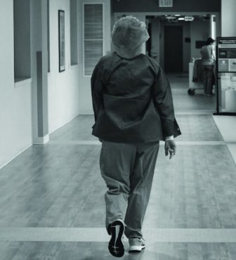 Healthcare worker walking down the hall